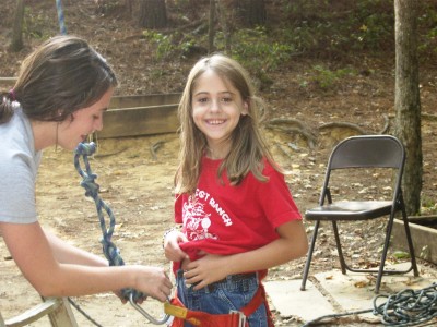 Anna Leach getting ready to climb a very tall pine tree.